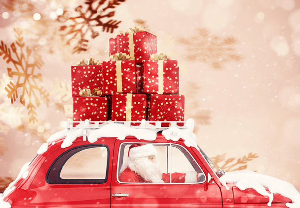 Santa Claus on a red car full of Christmas present with snowflakes background drives to deliver - Фото, изображение