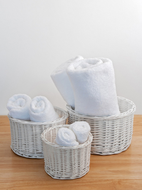 Toalhas limpas em cestas de vime branco
 - Foto, Imagem