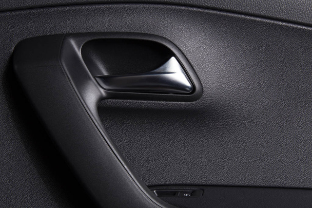Car door handle inside. Clean car interior. Background for car cleaning themes. - Photo, Image