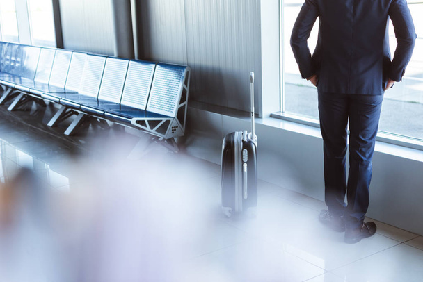 back view of businessman standing at departure lounge in airport - Fotó, kép