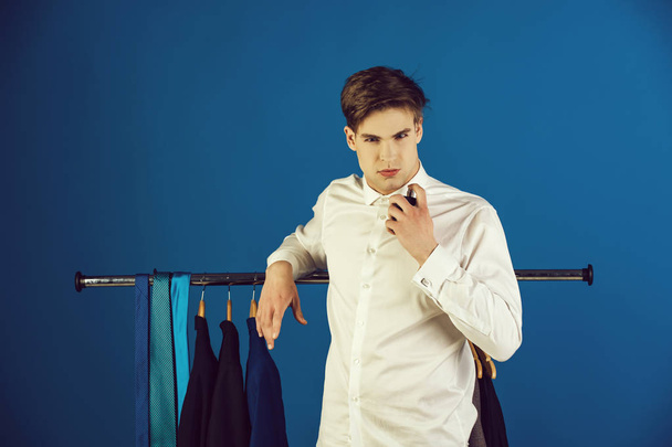 sexy man with bottle of perfume in shirt with hanger - Foto, Imagem
