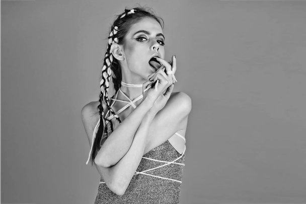 girl with makeup, stylish hair licking fingers with tongue - Foto, Bild