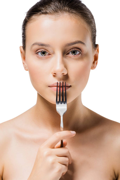 young beautiful woman with silver fork near mouth - Фото, изображение