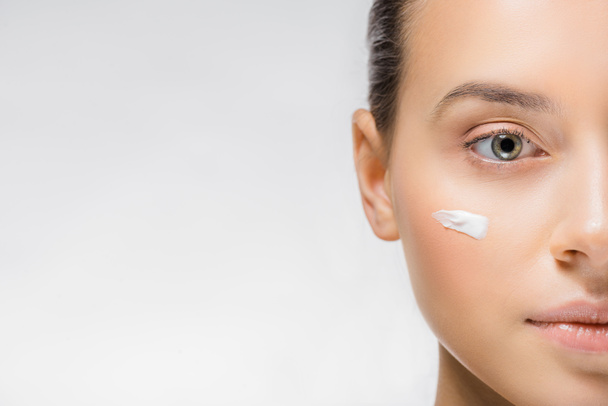 young woman with white facial cream on cheek - Photo, Image