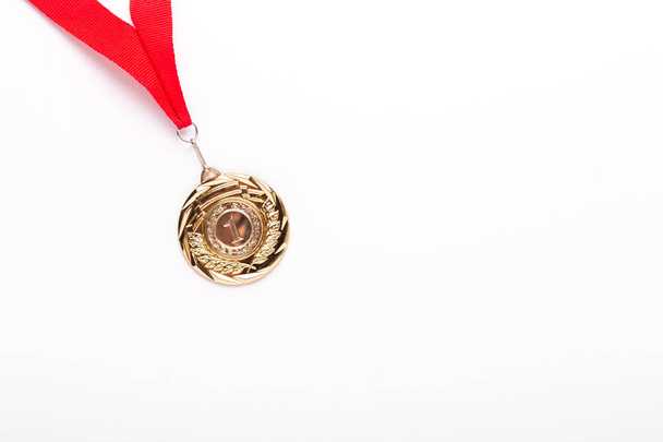 Gold medal with red ribbon on white background. Isolated. Copy space - Foto, immagini