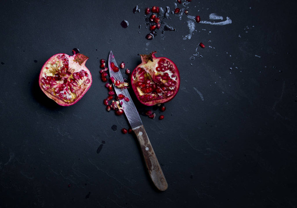 Pomegranate fruit on a dark background - Fotografie, Obrázek