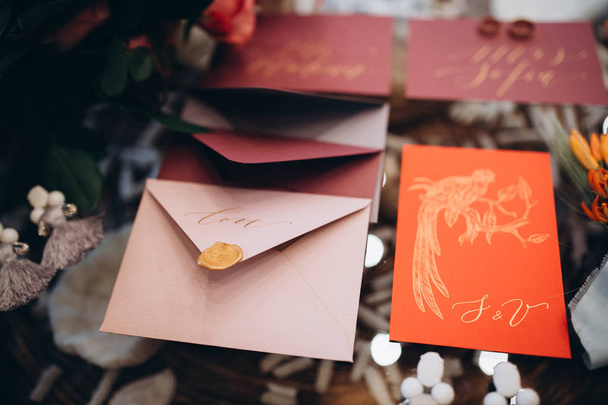 A wedding concept. Invitation and items, Different colored paper envelopes on the table, background. - Photo, Image