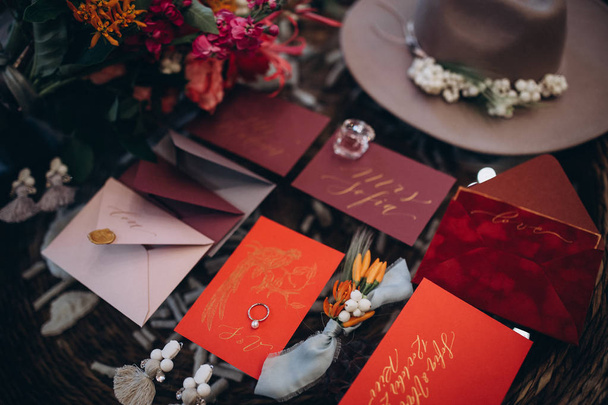 A wedding concept. Invitation and items, Different colored paper envelopes on the table, background. - Valokuva, kuva