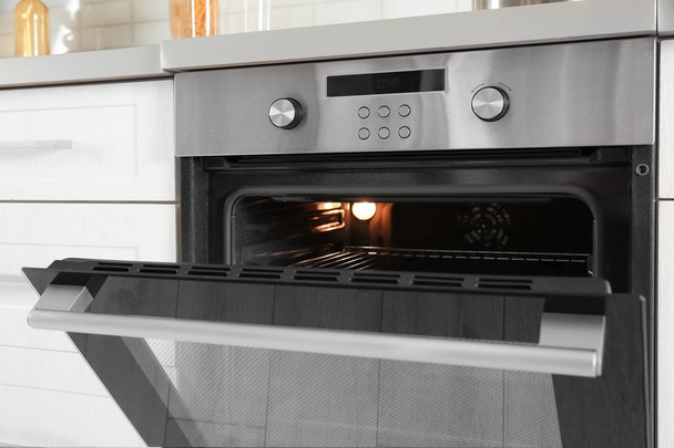 Open modern oven built in kitchen furniture, closeup - Fotografie, Obrázek