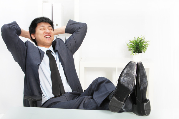 Asian businessman relaxing with his feet up - Photo, Image