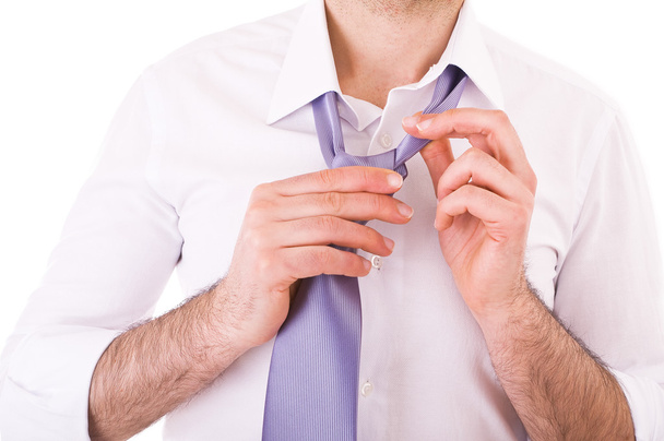Businessman easing his tie. - Foto, afbeelding