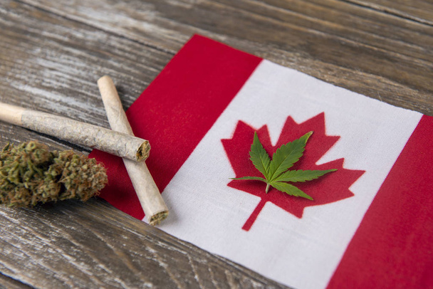 Canadian flag with assorted marijuana products - medical marijuana concept background - Fotó, kép