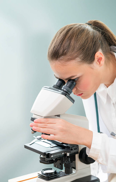 Scientist researcher using microscope in laboratory. Medical healthcare technology and pharmaceutical research and development concept. - Foto, Imagem