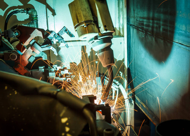welding robots represent the movement. In the automotive parts industry. - Photo, Image