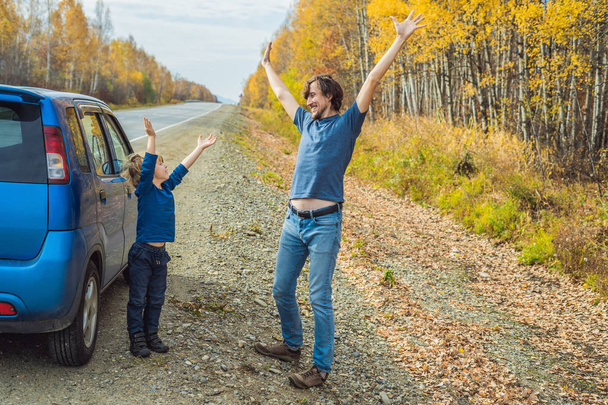 Father and son having fun on roadside while family trip. - Photo, Image