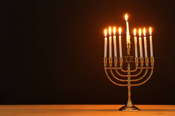 image of jewish holiday Hanukkah background with menorah (traditional candelabra) and candles - 写真・画像
