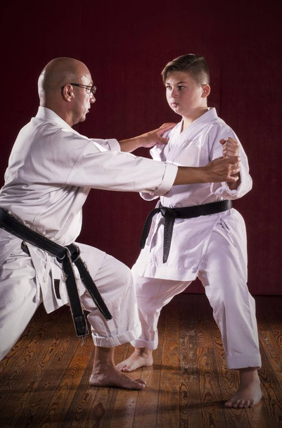 Karate instructor teaching martial arts to a kid - Photo, Image