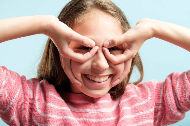 funny joyful playful girl look hand binoculars - Foto, imagen