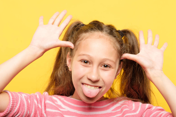 girl sticking tongue grimacing childish behavior - Foto, Imagen