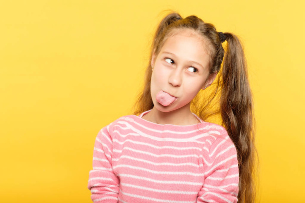 naughty girl sticking tongue frolicking childish - Фото, изображение