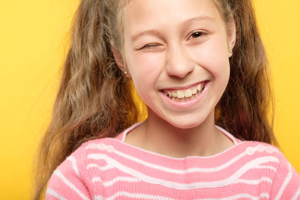 cute smiling girl winking child carefree lifestyle - Foto, afbeelding
