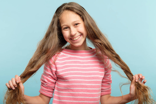 smiling adolescent girl pig tails hair carefree - Фото, изображение