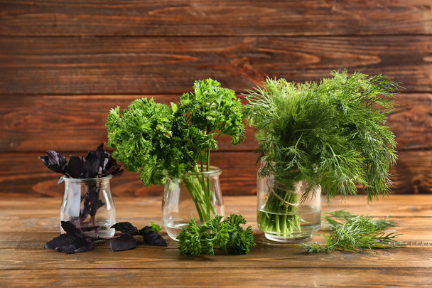 Jars with fresh aromatic herbs on wooden table - Photo, Image