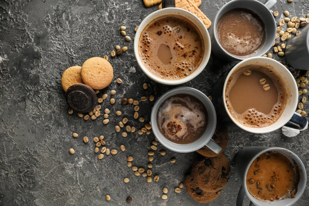 Many cups with tasty aromatic coffee and cookies on grey table, flat lay - Photo, Image