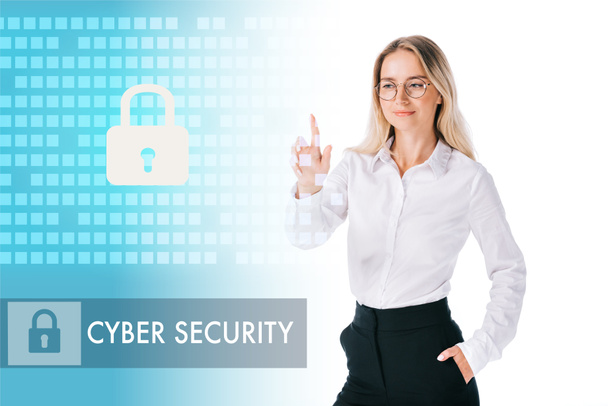 portrait of smiling businesswoman in formal wear pointing at cyber security sign isolated on white - Foto, immagini