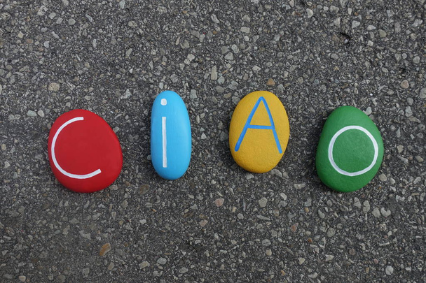 Ciao text composed with colored stones over asphalted road - Photo, Image