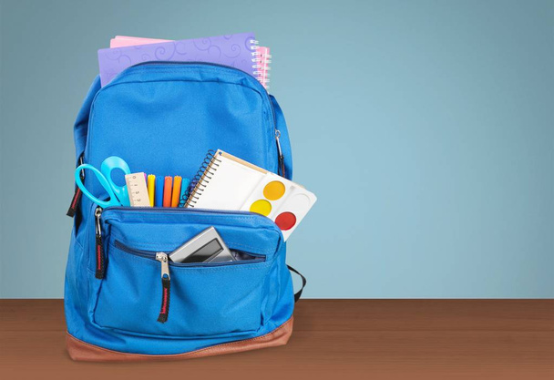 School Backpack with stationery on wooden table  - Zdjęcie, obraz