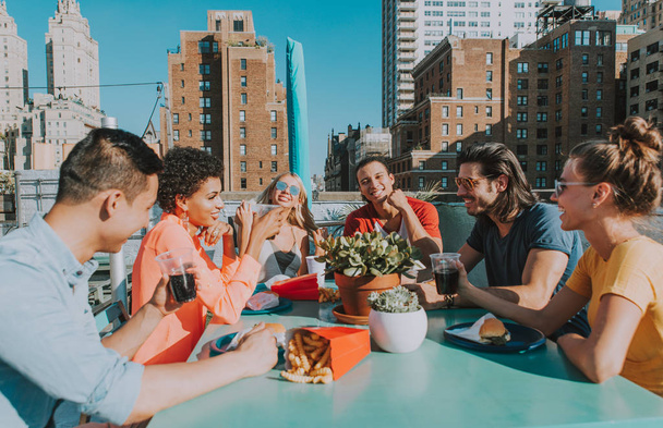 Group of friends apending time together on a rooftop in New york city, lifestyle concept with happy people - Photo, Image