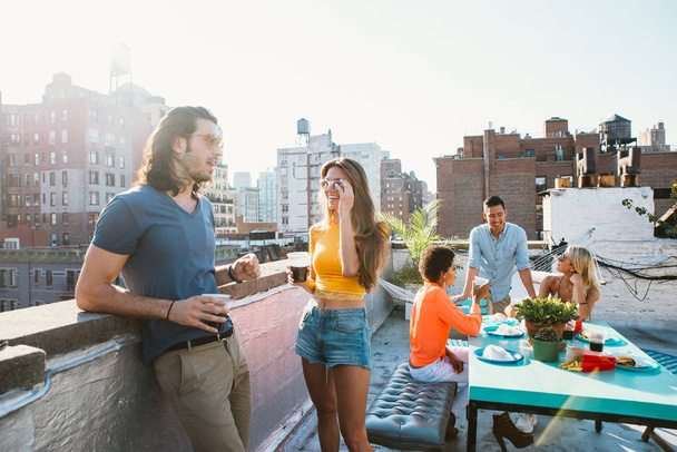 Group of friends apending time together on a rooftop in New york city, lifestyle concept with happy people - Φωτογραφία, εικόνα