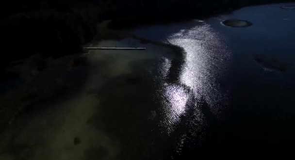 flight over the small bridge on the lake near forest at evening night - Felvétel, videó