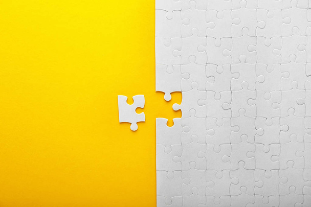 White jigsaw puzzle with piece on color background - Φωτογραφία, εικόνα