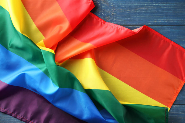 Rainbow LGBT flag on wooden background, top view - Photo, Image