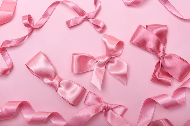 Pink ribbons and bows on color background - Photo, Image