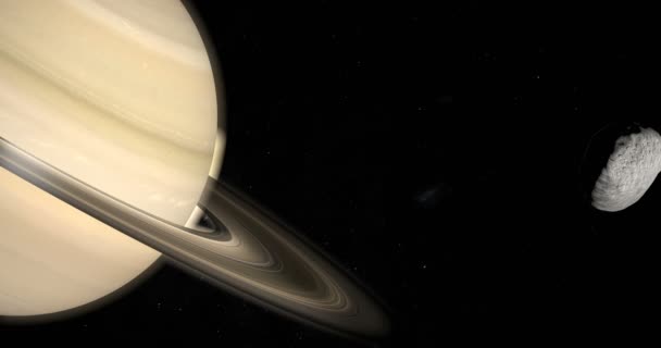 Janus księżyc na orbicie wokół planety Saturn w przestrzeni kosmicznej - Materiał filmowy, wideo
