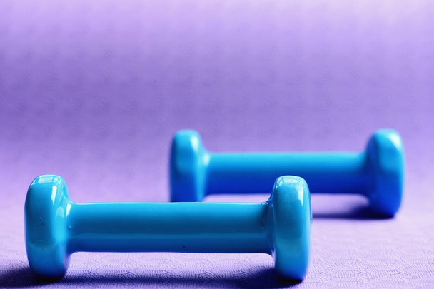 Barbells made of plastic, close up. Dumbbells in cyan blue - Foto, imagen