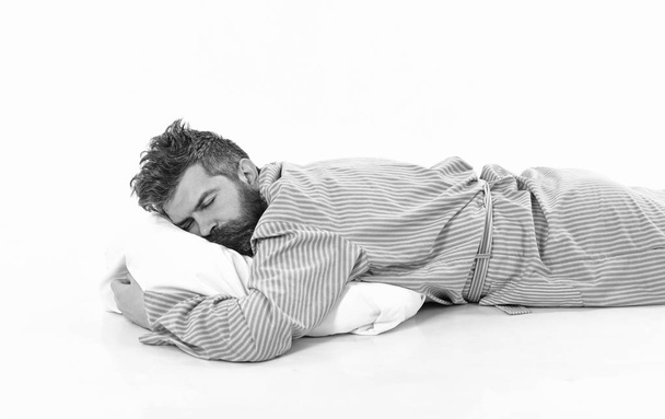 Man with sleepy face lies on pillow. - Foto, Imagen