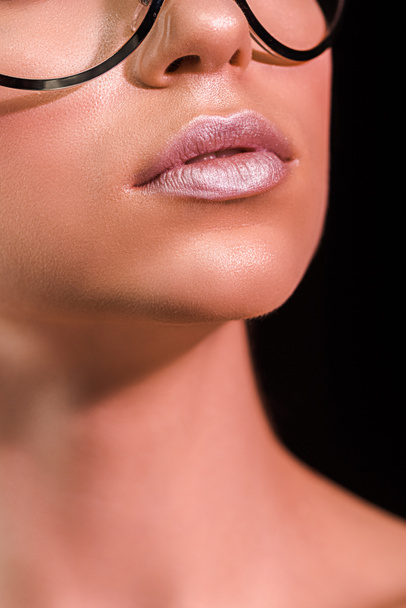 cropped shot of woman with pink lipstick on lips isolated on black - Valokuva, kuva