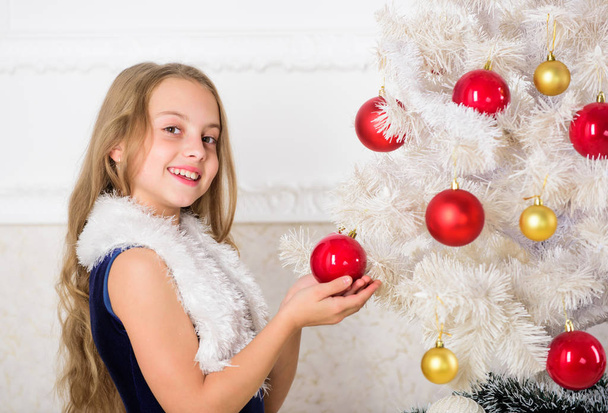 Family holiday concept. Girl velvet dress feel festive near christmas tree. Spread christmas cheer. Kid happy because holiday season arrives. Winter holiday concept. Very special time of year - Foto, imagen