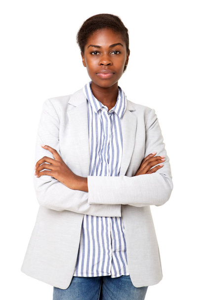 Portrait of serious young african american woman standing against isolated white background with arms crossed - Photo, Image