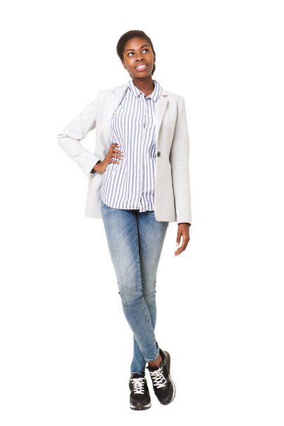 Full body portrait of young african american woman in blazer thinking and looking up - Foto, Imagen