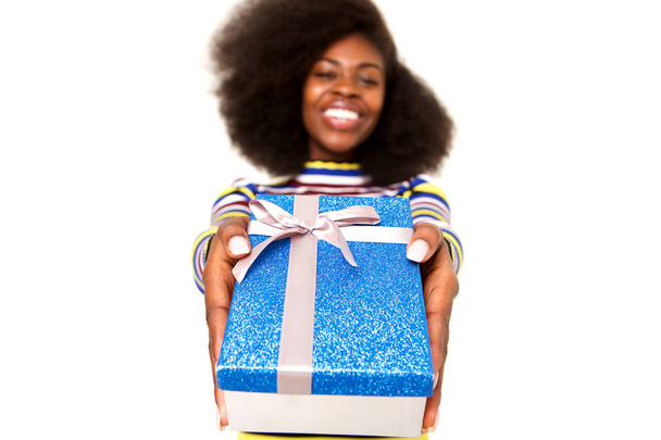 Portrait of happy young black woman holding gift box against isolated white background - Valokuva, kuva