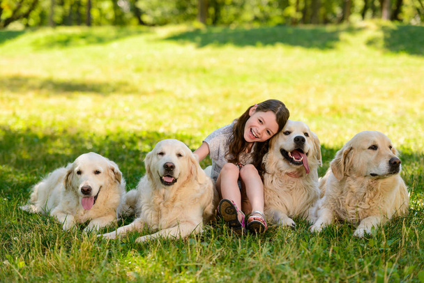 Little girl and four dogs - Photo, Image