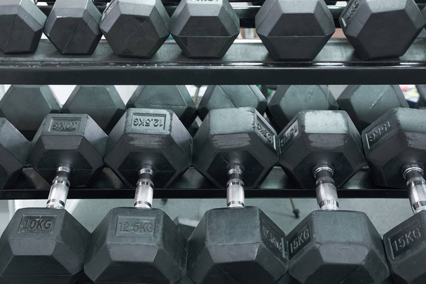 heavy dumbbells on the stand in gym - Photo, Image