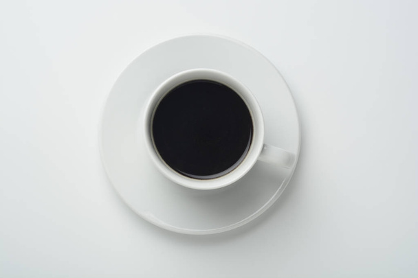 Cup of coffee on white background, top view - Fotó, kép