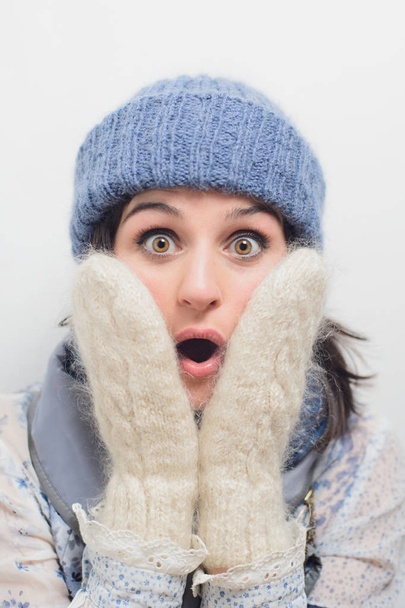 Close up portrait of shocked young woman face. adult girl in winter clothes. wow, omg, secret, horror and big sale concept. stock photo image - Valokuva, kuva