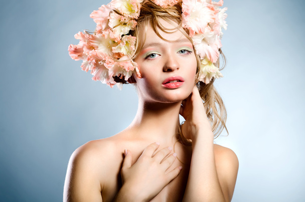Portrait of young blonde woman with flowers - Foto, Imagen